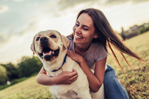 Young woman with golden labrador outdoors